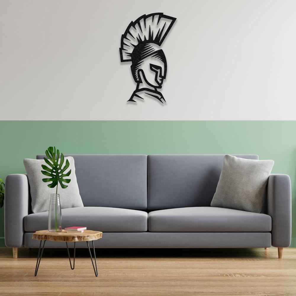 Spartan helmet wall art mounted above a modern gray sofa with a two-tone wall design in green and white.