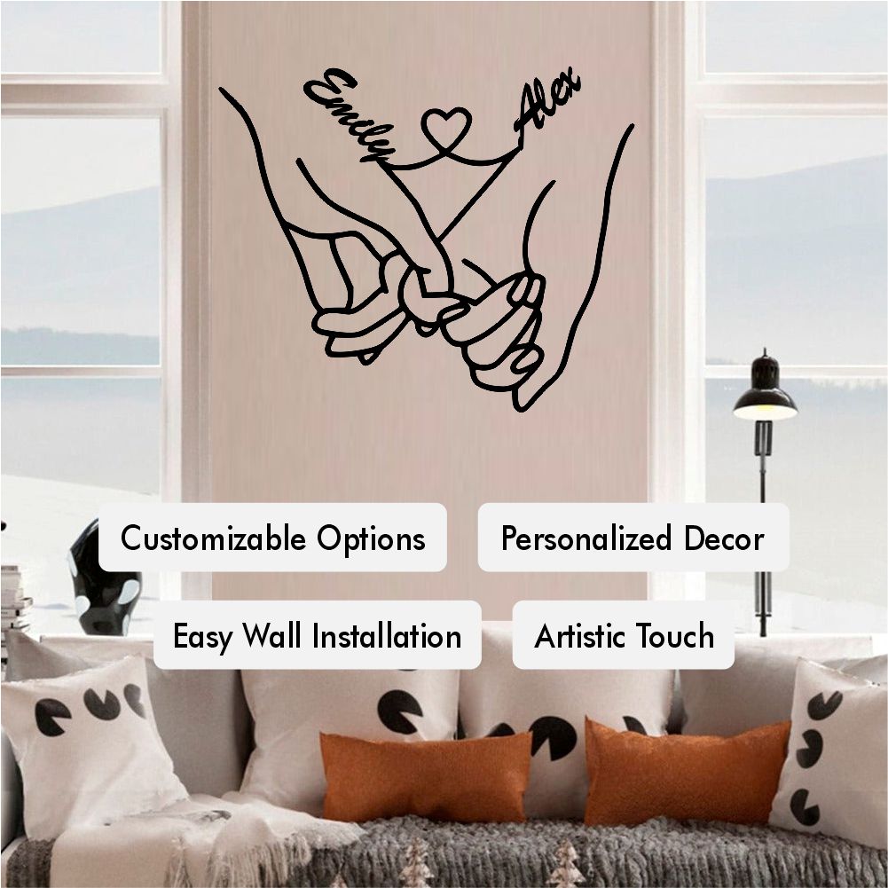 Personalized metal wall decor featuring two holding hands with customizable "her name" and "his name" text connected by a heart, elegantly placed above a modern black and white bed.