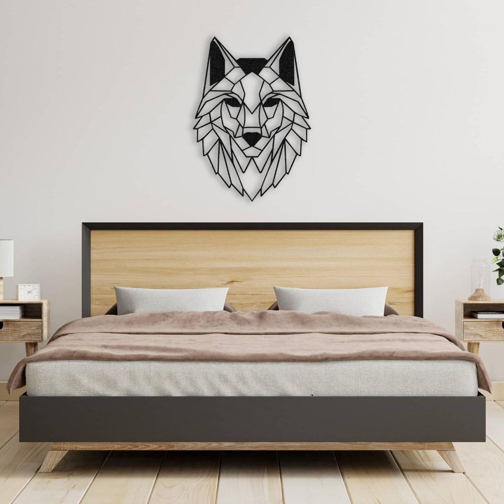 Geometric wolf head metal wall art in black, mounted on a white wall above a modern wooden bed with a black frame. The bed features soft beige and brown bedding, flanked by matching wooden bedside tables holding small decor items like a clock and a lamp.