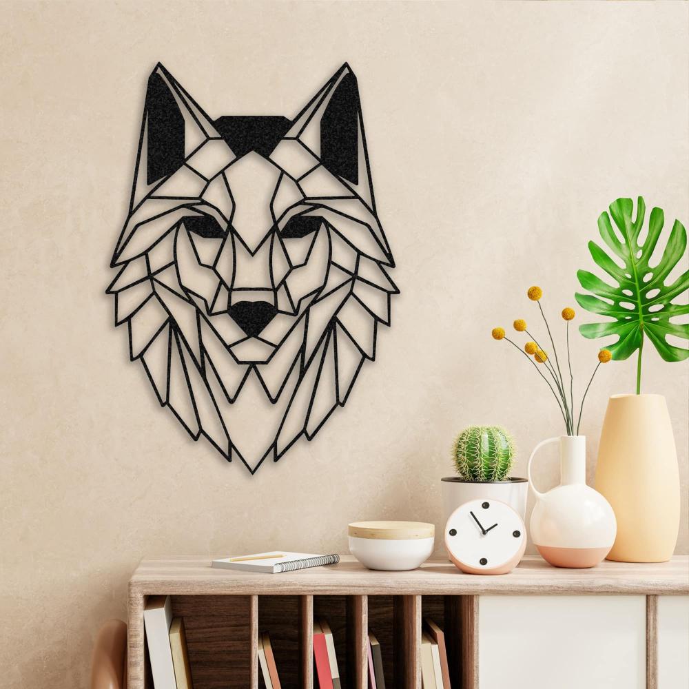 Black geometric wolf head metal wall art mounted on a beige wall above a minimalist wooden shelf. The shelf is styled with books, a white and peach-colored clock, a vase with yellow flowers, a potted cactus, and a tropical green leaf in a light yellow vase, creating a fresh and modern decor setup.