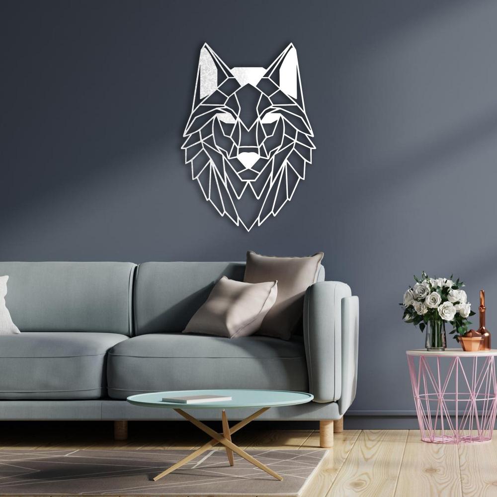 Geometric wolf head metal wall art in white, mounted on a dark gray wall above a light gray modern sofa. The decor is complemented by a pink wireframe side table with a bouquet of white roses and a gold-accented coffee table on a wooden floor.