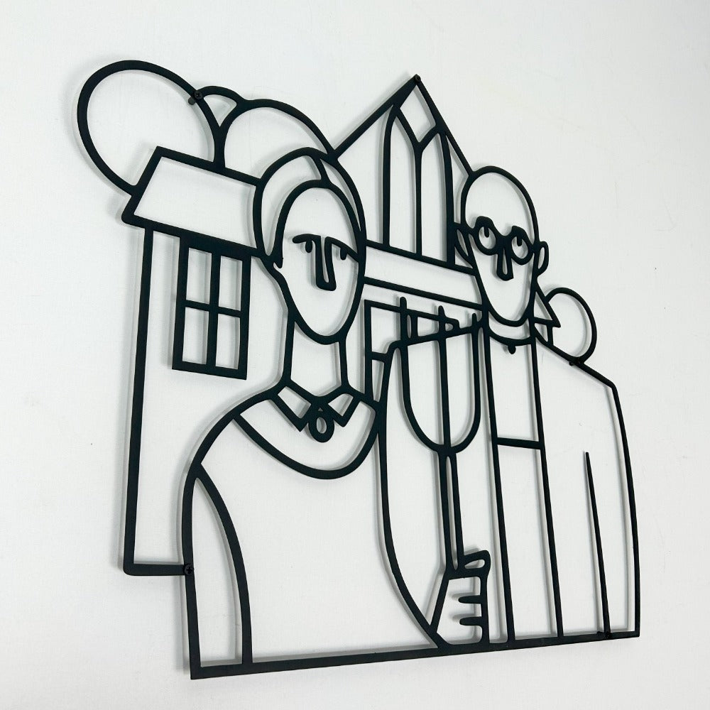 A close up and direct view of the American Gothic metal wall art in black, set against a plain white wall, emphasizing its elegant line art design.