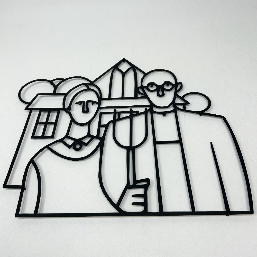 A close-up view of a metal wall art piece inspired by the American Gothic painting, showcasing clean black outlines of the farmer and his wife with their iconic house in the background.
