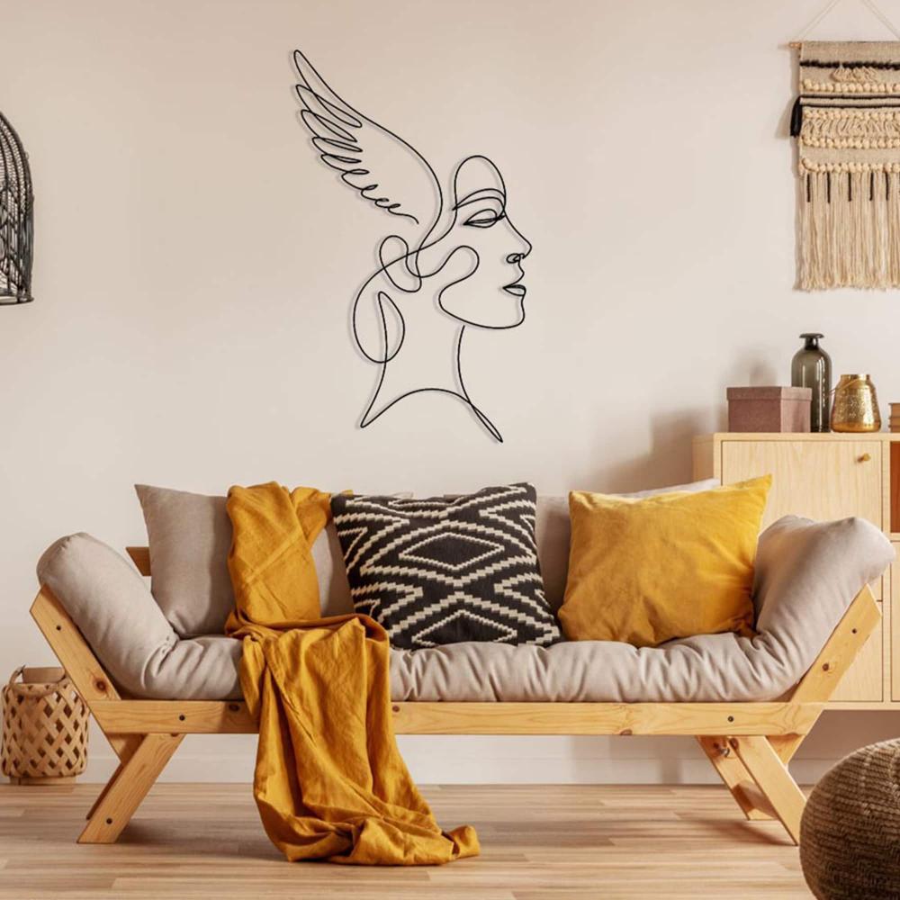 A cozy living room with a minimalist wooden sofa adorned with mustard and patterned pillows, featuring an angelic winged woman line art metal wall decor on a cream wall.