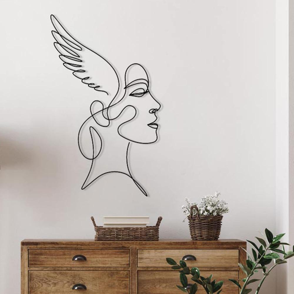 A natural wooden dresser styled with wicker baskets and potted plants, featuring a winged woman line art wall decor on the wall above.