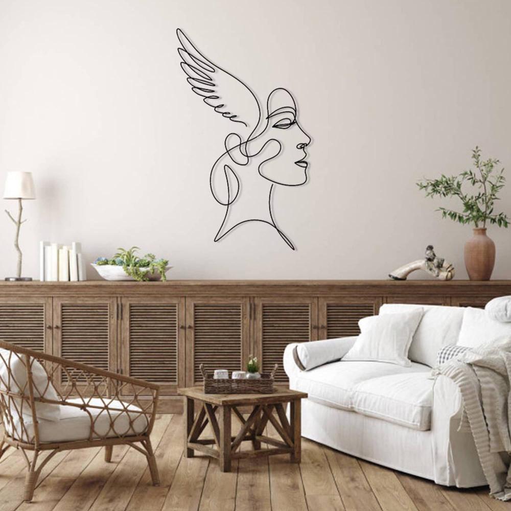 A rustic-style living room with wooden furniture, including a cane chair and coffee table, with angelic winged woman wall art as the centerpiece on the wall.