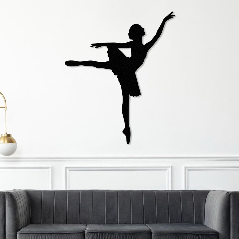 Elegant black ballerina metal wall art displayed above a gray sofa, complementing a minimalist and modern living space.