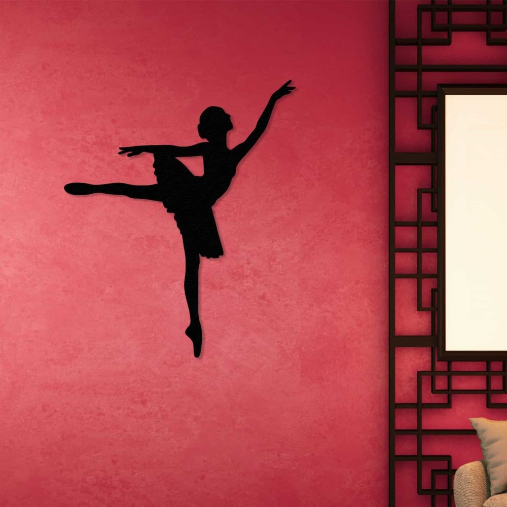 Black ballerina silhouette metal art mounted on a vibrant pink wall, adding a bold artistic statement to the room.