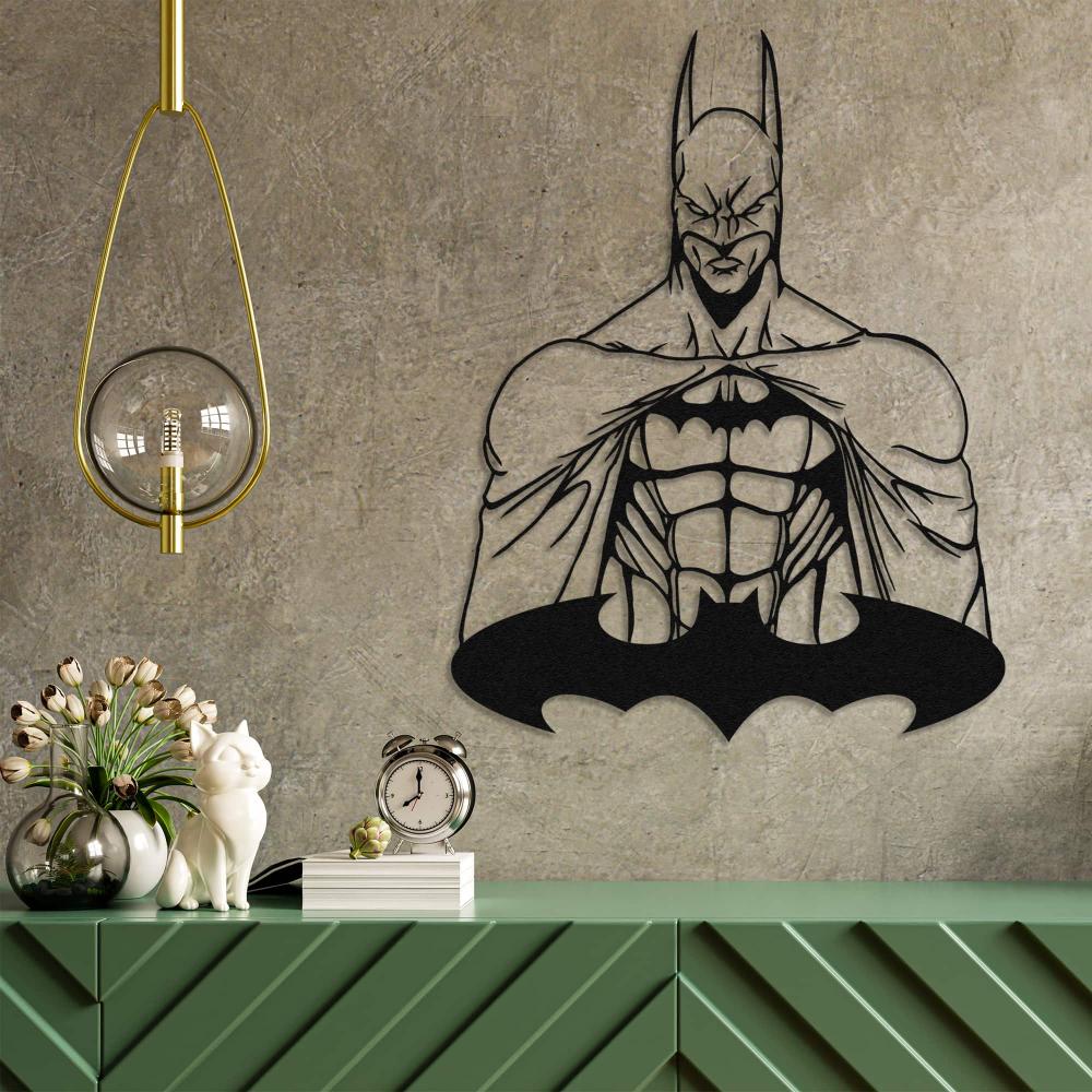Batman-themed metal wall art mounted on a textured concrete wall, accompanied by a green modern console table adorned with decorative items including a white ceramic cat, a vintage-style clock, and a hanging pendant light.
