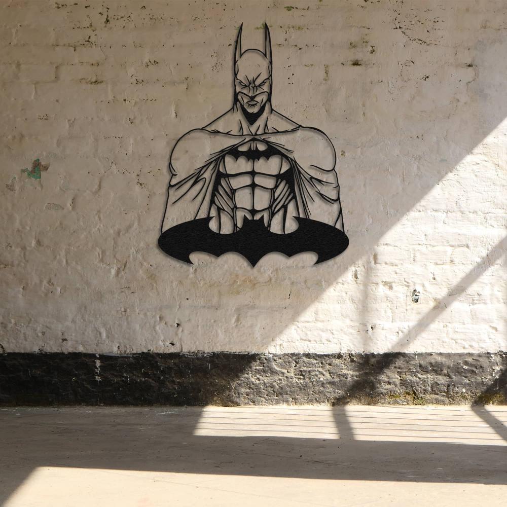 Black metal Batman wall art featuring a muscular design and iconic bat symbol, mounted on a rustic white brick wall with natural light streaming through.