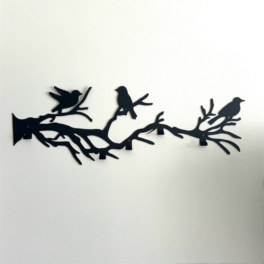 A black metal wall-mounted coat rack featuring birds perched on tree branches. The minimalist design showcases detailed bird silhouettes sitting on interwoven branches, offering both functionality and a decorative nature-inspired element for home interiors.