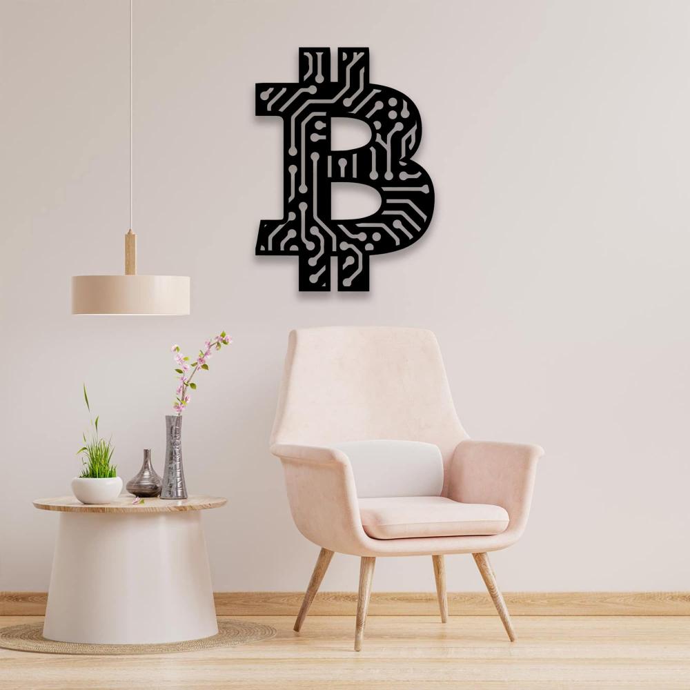 Black Bitcoin-inspired wall art featuring a circuit board design, mounted on a light beige wall, above a modern light pink armchair and a round table adorned with green plants and a vase of pink flowers.
