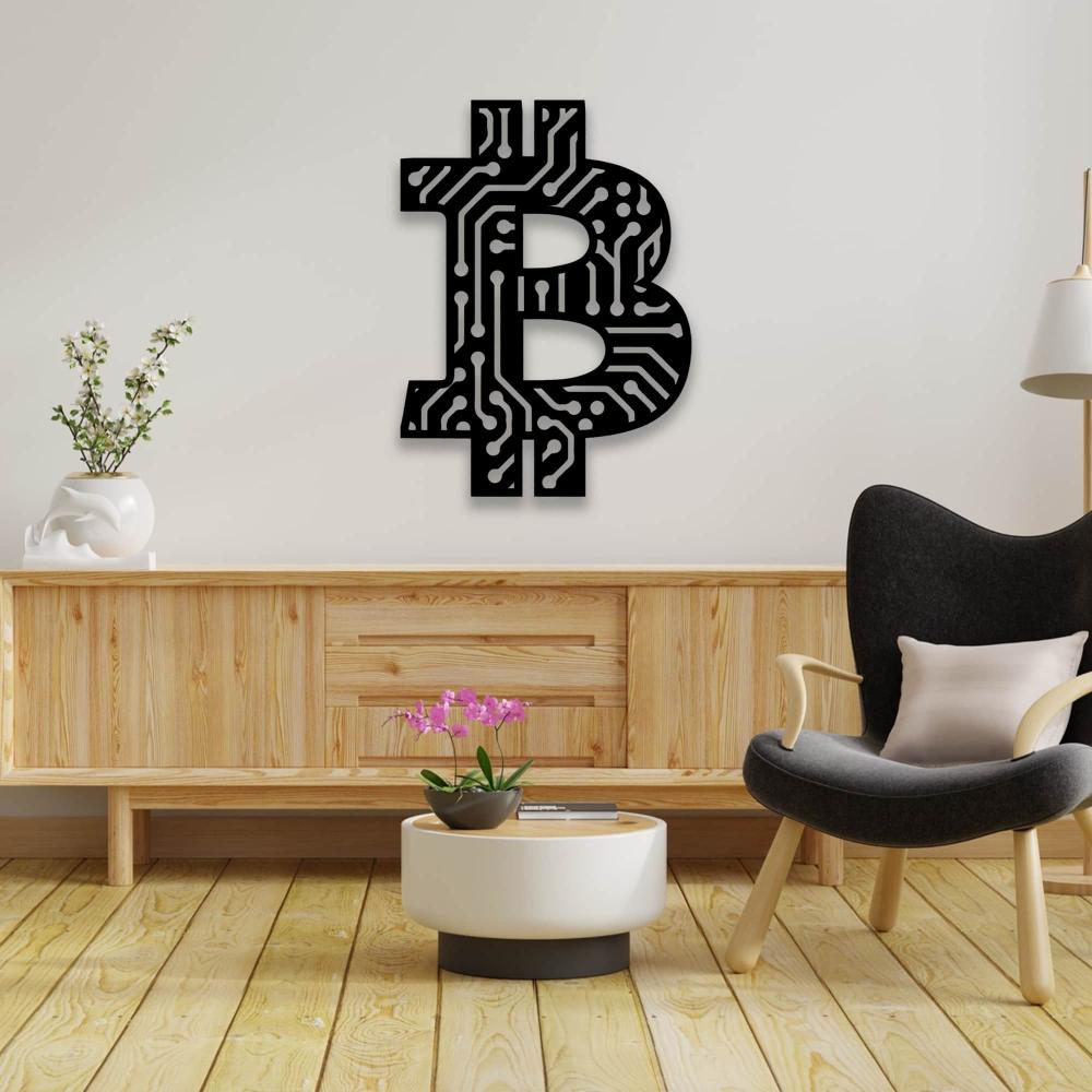 Black Bitcoin wall art with a circuit board design, displayed on a light-colored wall above a wooden cabinet, accompanied by a modern black chair and a small table with an orchid.