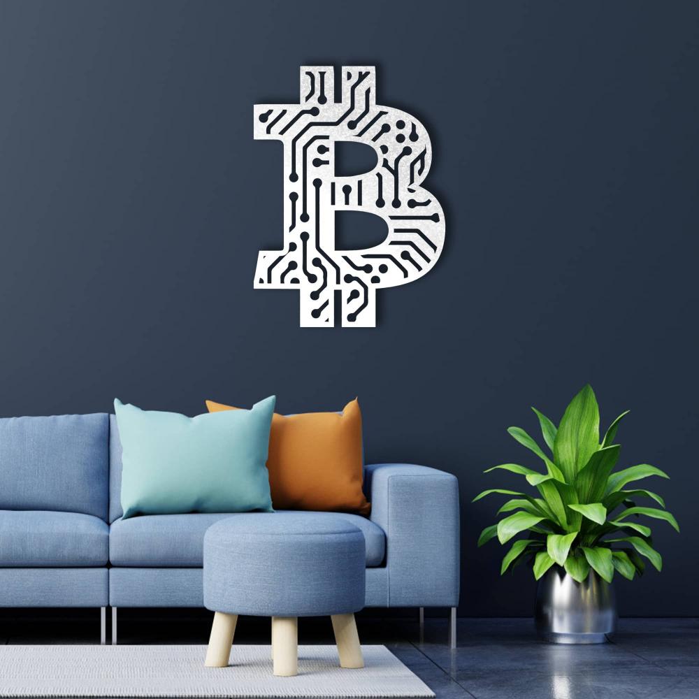 White Bitcoin-themed wall art featuring a circuit board pattern, displayed on a dark blue wall above a modern blue sofa with colorful pillows and a round ottoman, complemented by a green plant in a metallic pot.