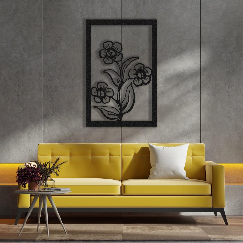 Black metal floral wall art adding an elegant touch to a living room with a bold yellow sofa and minimalist decor.