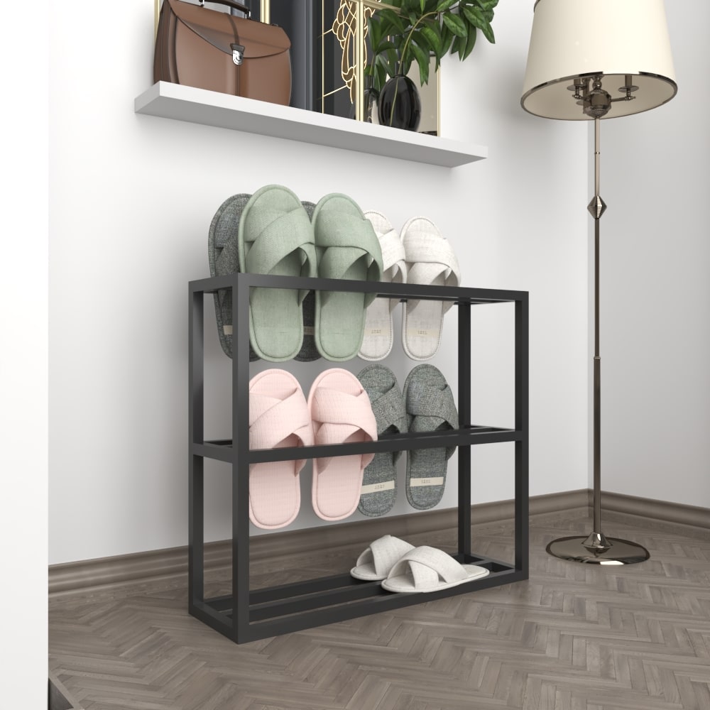 A sleek black metal slipper rack with no slippers, showcased against a plain white background to highlight its clean and structured design