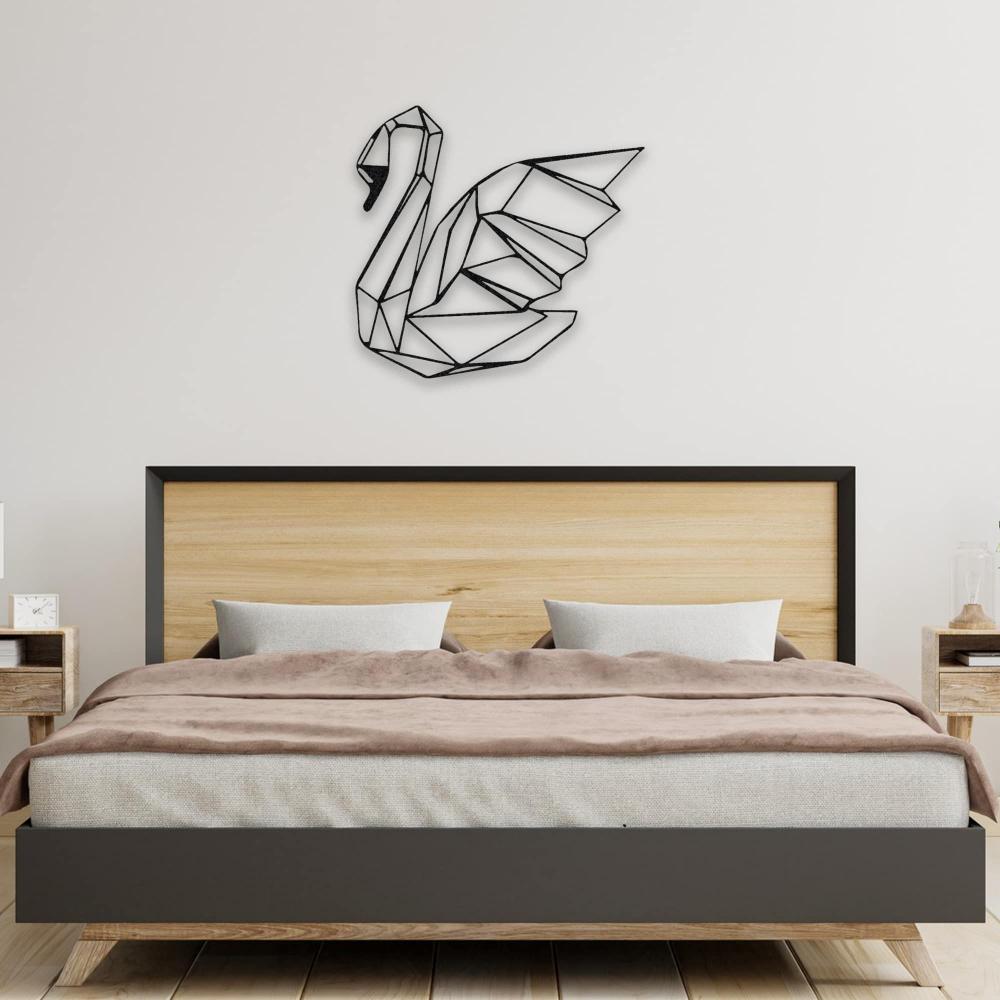 A stylish black swan metal wall art positioned above a wooden bed with neutral-toned bedding in a contemporary bedroom.