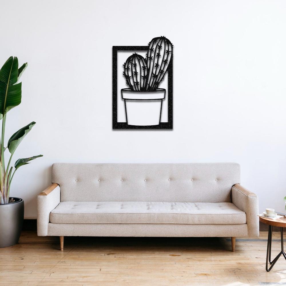 A minimalist living room setup with a neutral beige sofa and a black "Cactus in Vase" metal wall art on a white wall, paired with a potted green plant for a fresh vibe.