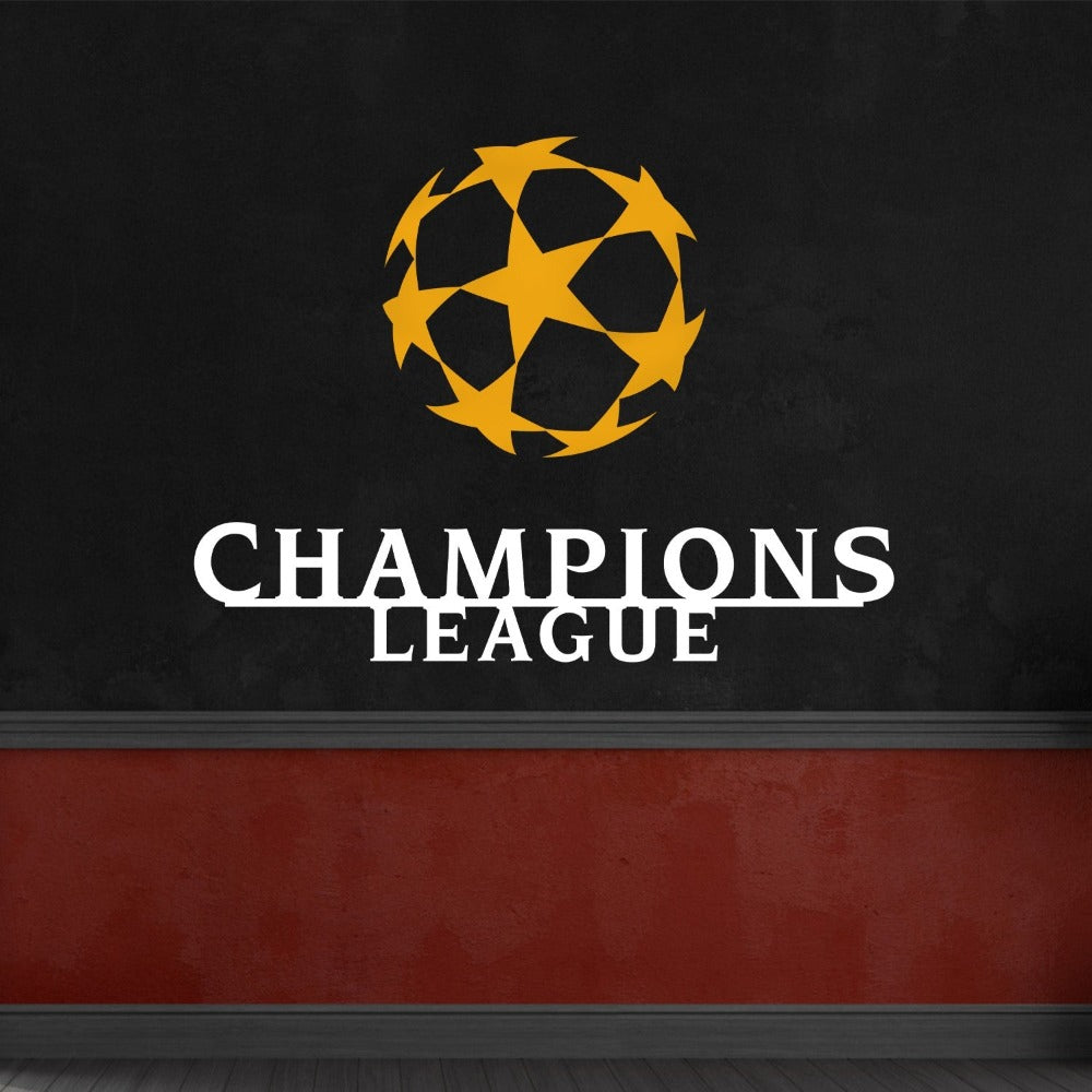Black and gold Champions League wall art featuring a star-patterned ball, displayed on a textured white brick wall with industrial-style decor.