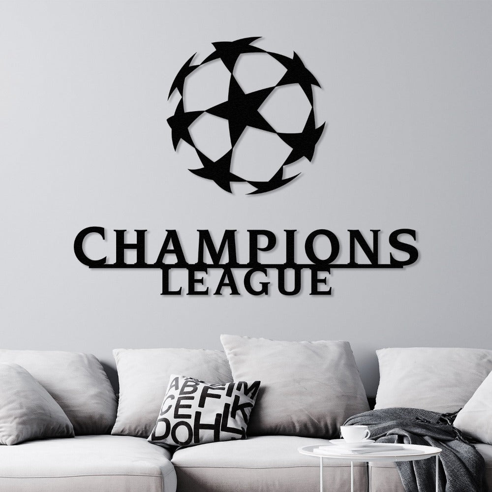 Modern black Champions League wall art with a star-patterned ball design, mounted on a neutral wall above a light-colored sofa in a contemporary living room.