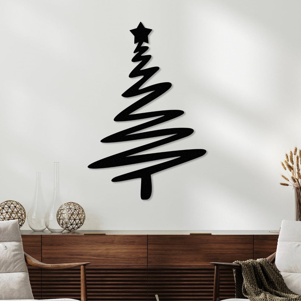Black metal wall art featuring a modern Christmas tree design with a star on top, mounted on a white wall above a wooden console, styled with decorative vases and cozy furniture in a living room.