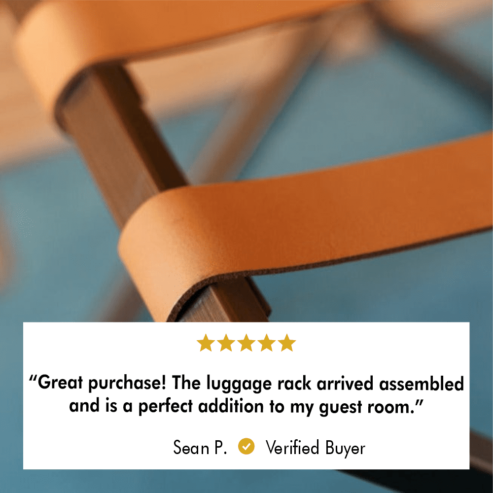 Close-up of tan leather straps on a metal luggage rack, highlighting the fine craftsmanship and sleek design with a verified customer review