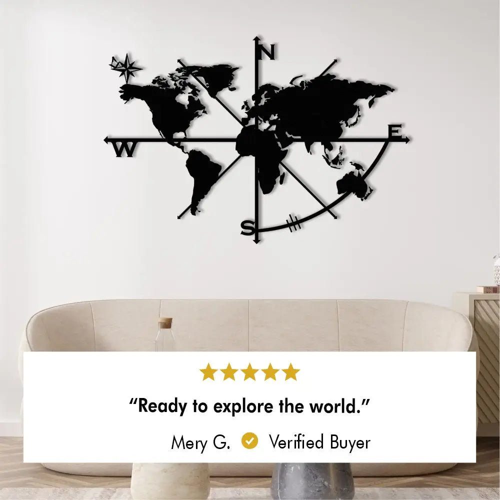 Metal world map wall art with compass design, displayed above a modern sofa.