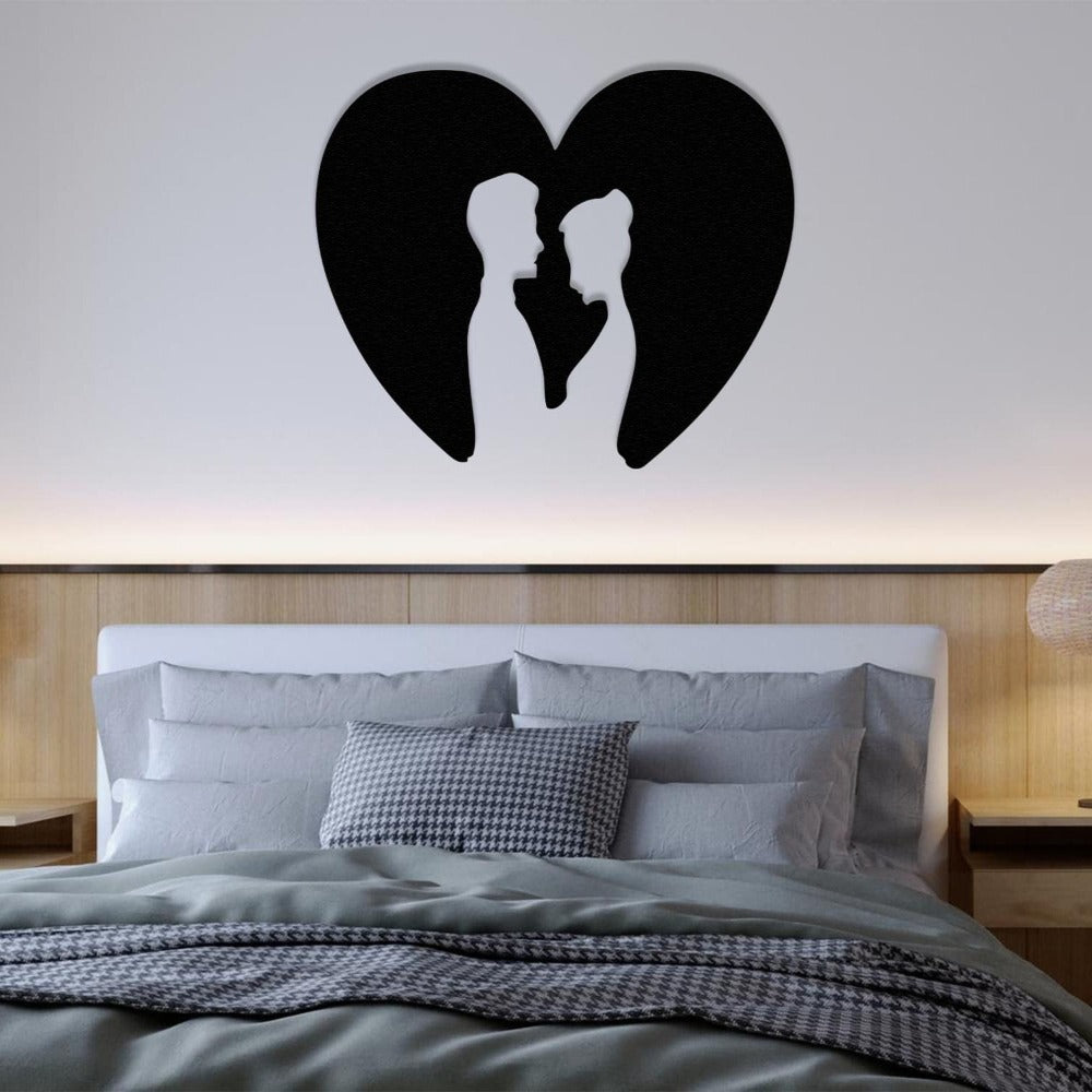 Romantic heart-shaped metal wall art with a couple’s silhouette, styled as an elegant focal point above a cozy bed with soft lighting.