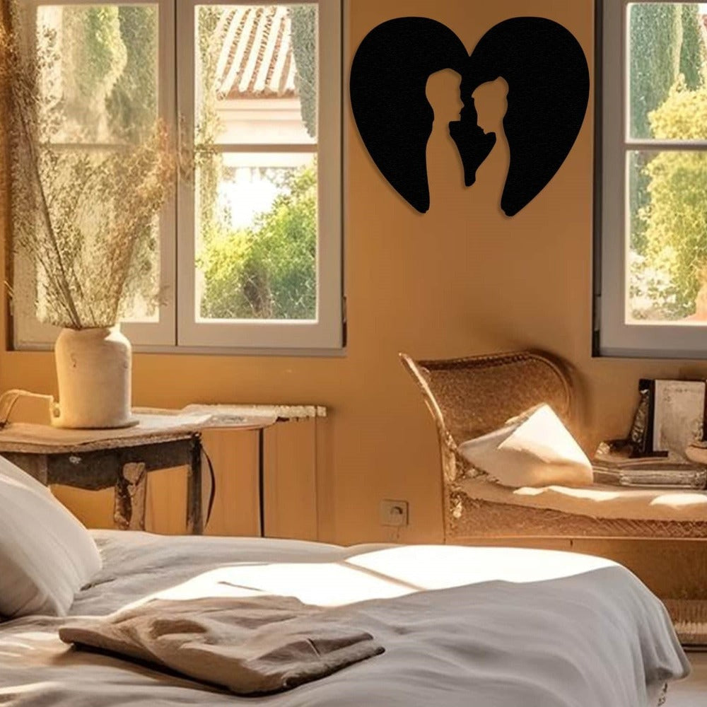 Black metal wall art of a couple inside a heart silhouette, elegantly displayed next to a bed in a warm and rustic bedroom with natural light streaming through the windows.