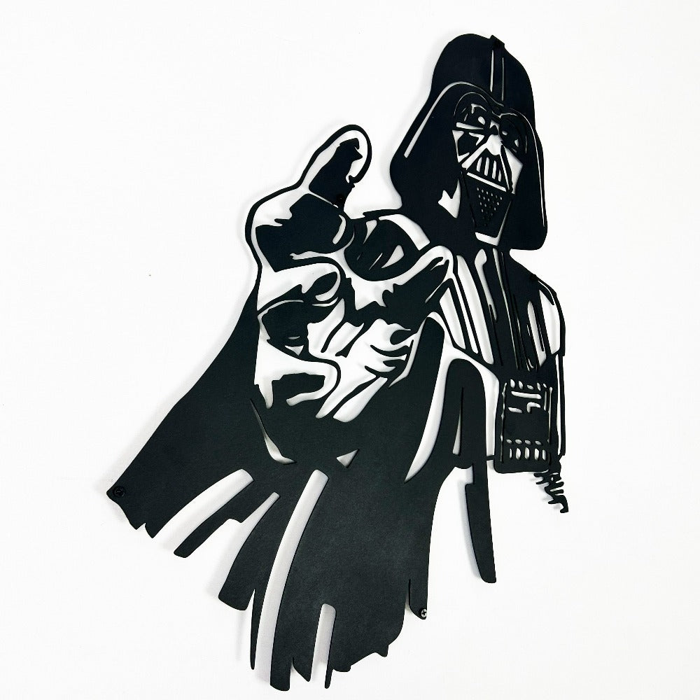Close-up of Darth Vader metal wall art featuring a bold black silhouette design with intricate details, showcasing the iconic character's dramatic pose on a white background.