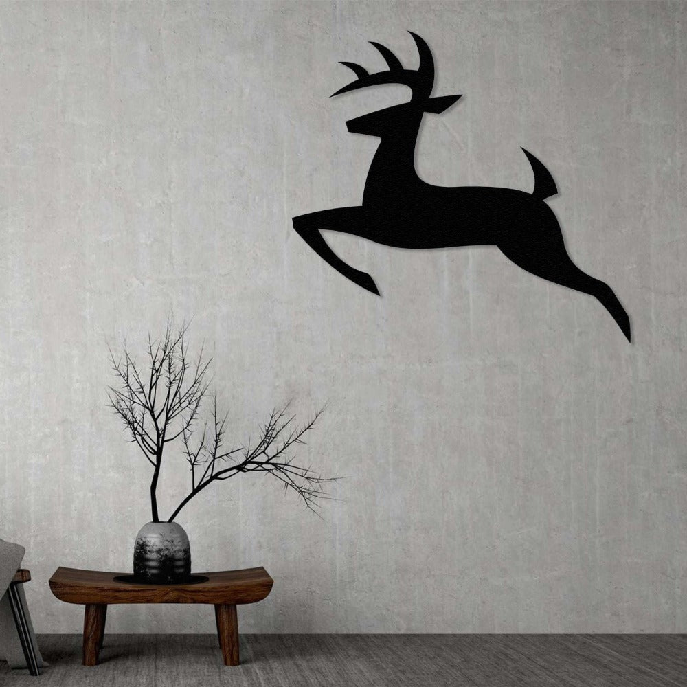 A sleek and minimalist black deer silhouette metal wall art, mounted on a gray concrete wall above a rustic wooden bench with a decorative vase and branches, adding elegance and charm to modern home decor.