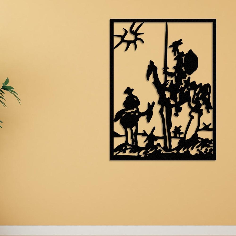 Black metal wall art depicting Don Quixote and Sancho Panza in an abstract design, mounted on a yellow wall with a minimalist indoor plant decor on the left side.