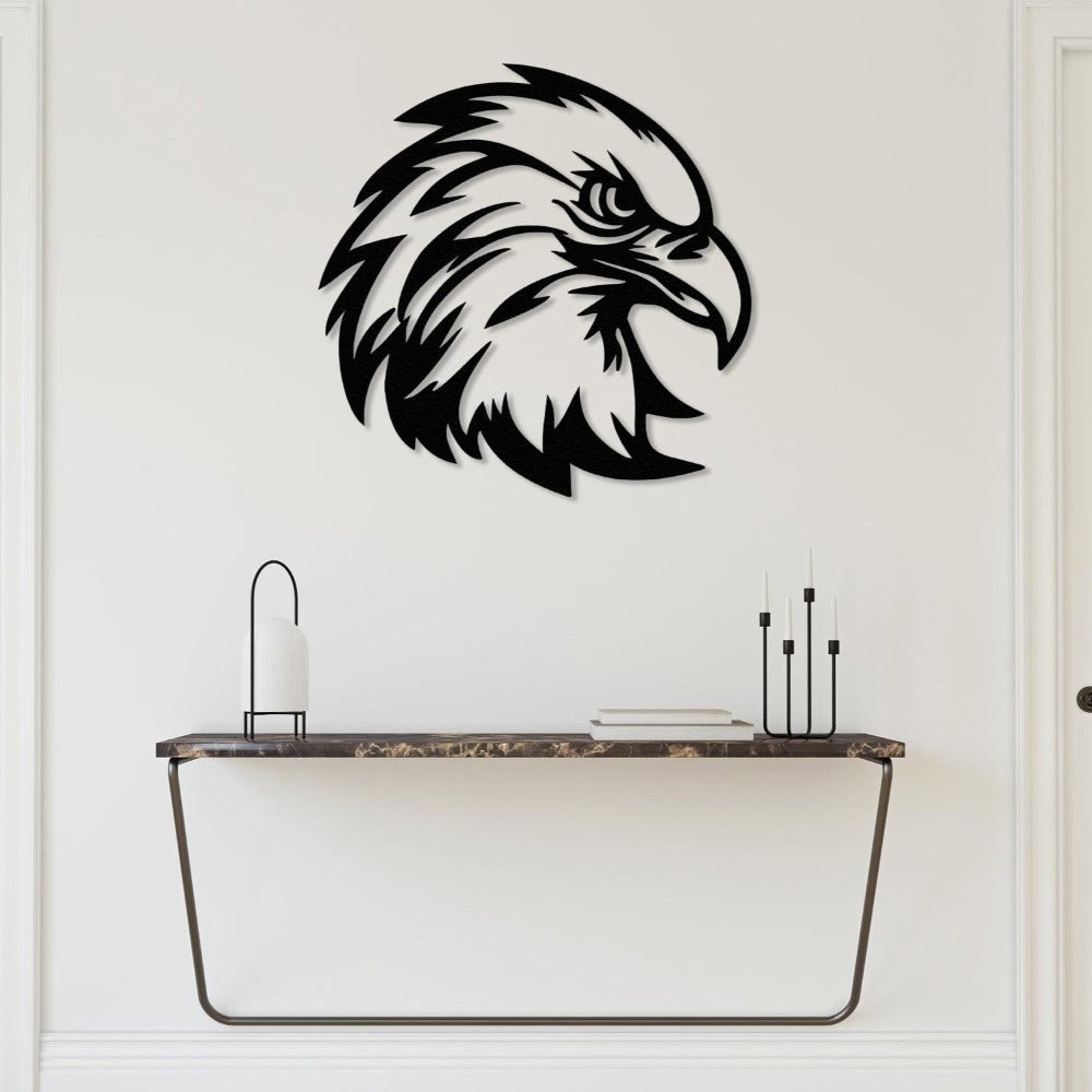 Black eagle head metal wall art displayed above a modern console table with minimalistic decor.