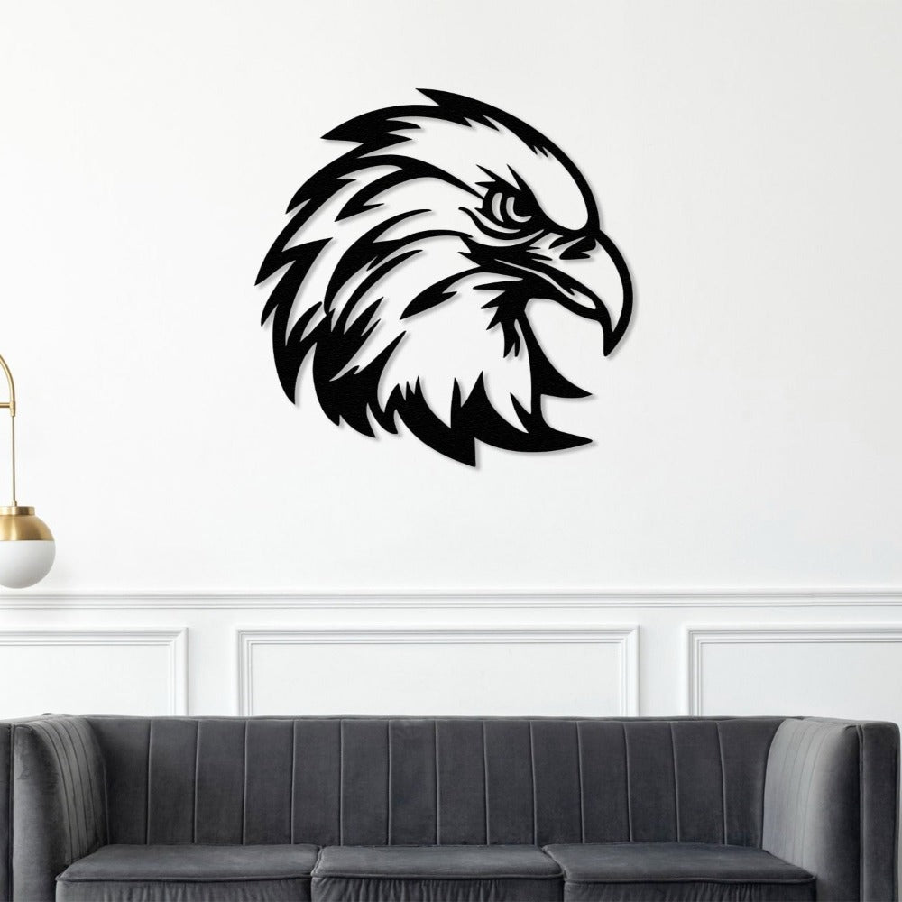 Black eagle head metal wall art mounted on a white wall above a grey sofa, adding a touch of elegance to the room decor