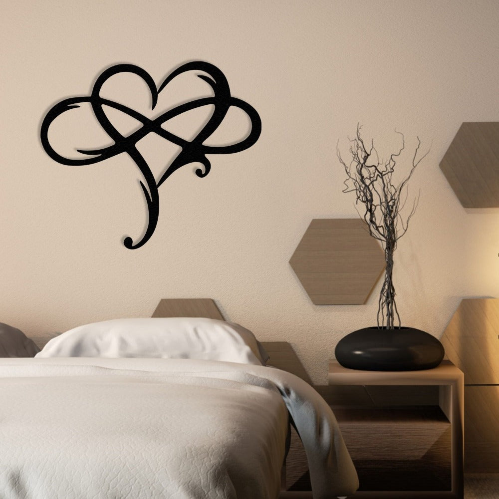 Black metal heart-shaped wall art with intricate loops, mounted on a minimalist white wall near a modern door, alongside a staircase illuminated by recessed step lights.