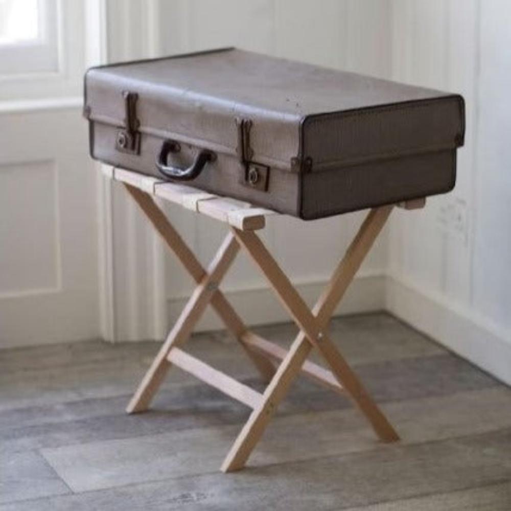 A wooden luggage rack supporting a vintage suitcase, ideal for guest rooms or hotel setups