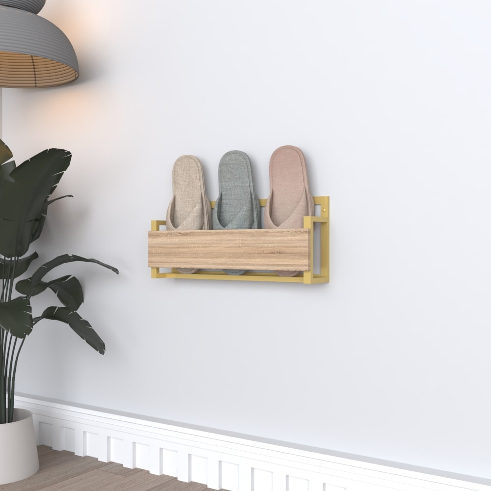 A stylish wall-mounted slipper rack with a gold metal frame and a wooden front, holding pastel-colored slippers in a bright, modern interior.