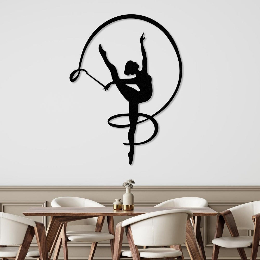 A modern dining area with a gymnast girl metal wall decor featuring a ribbon dance silhouette in black, mounted on a white wall, above a wooden table with elegant chairs