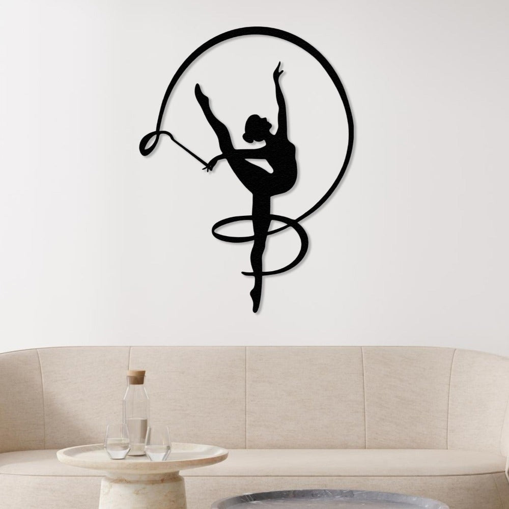 Black silhouette of a gymnast girl with a ribbon, beautifully displayed above a beige sofa in a minimalist living room.