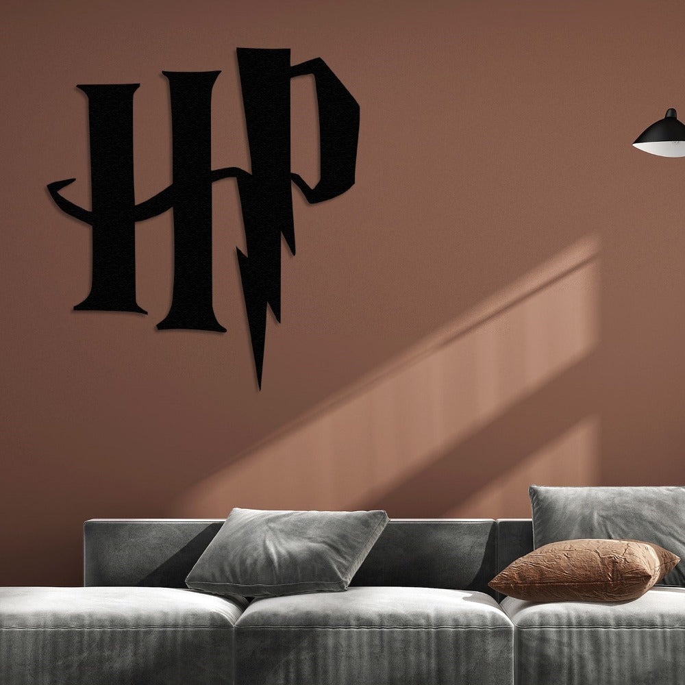 Black Harry Potter "HP" metal logo with a lightning bolt design mounted on a brown wall above a modern gray velvet sofa with decorative cushions, lit by soft lighting.