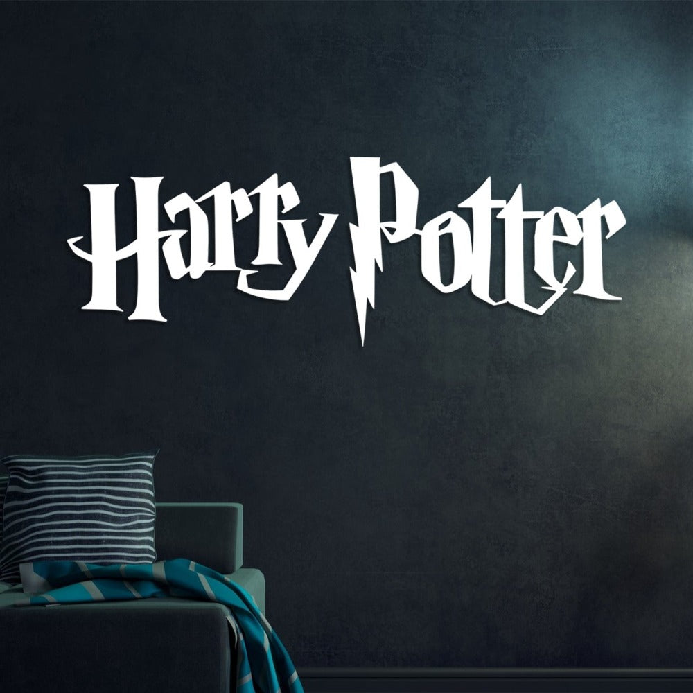 "Harry Potter" white metal wall art with a lightning bolt design, mounted on a dark-textured wall above a cozy armchair adorned with striped pillows and a teal blanket.