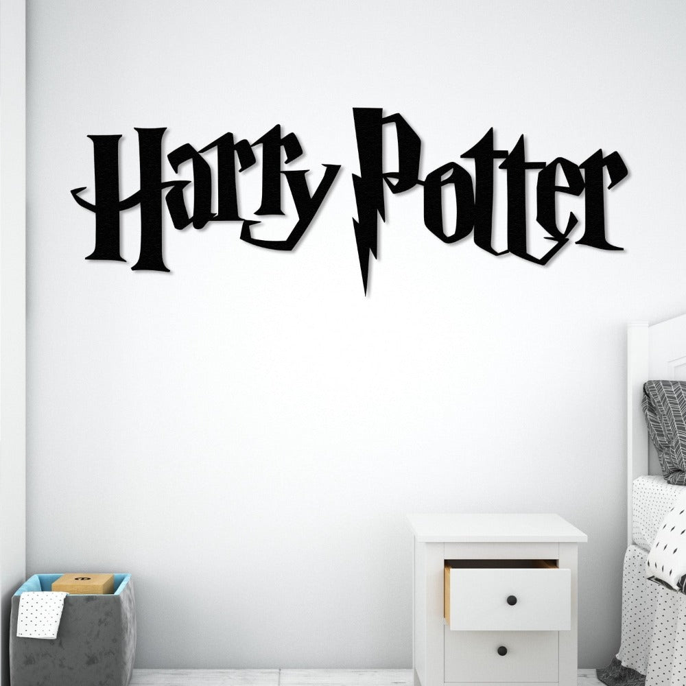 "Harry Potter" black metal wall art featuring the iconic lightning bolt design, mounted on a white wall in a minimalist bedroom with a bedside table and storage basket.