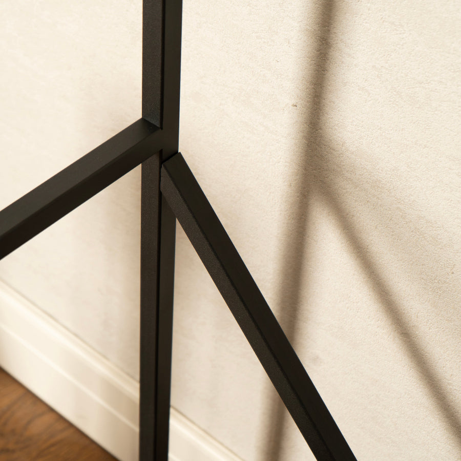 Black metal frame against a beige wall