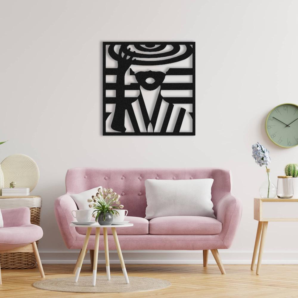 Lady with hat metal wall art in black, mounted above a pink tufted sofa with a white pillow, surrounded by modern decor elements including a small coffee table, plants, and a wall clock.