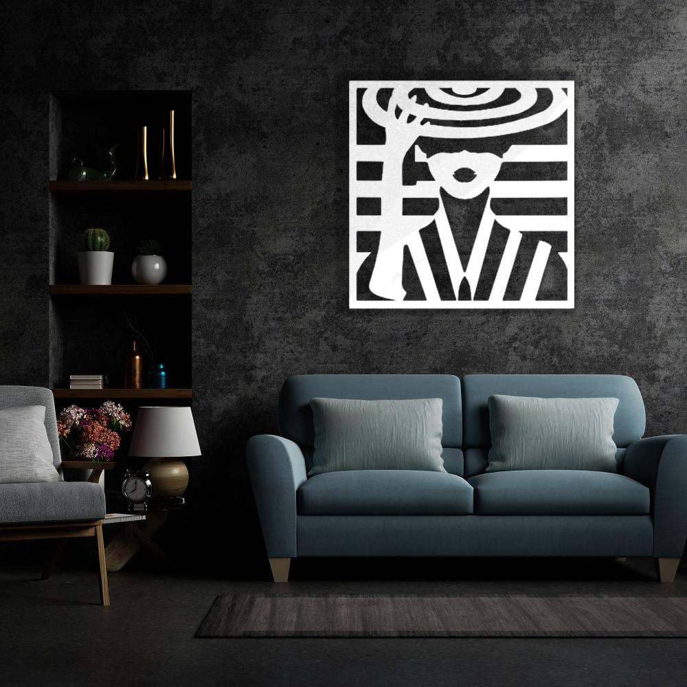 Modern white metal wall art of a lady wearing a stylish hat, displayed against a dark textured wall above a teal sofa with matching cushions in a sophisticated living room.