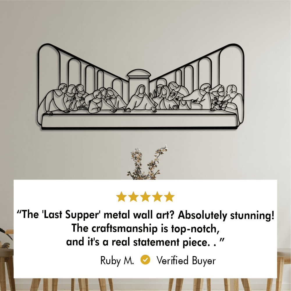 Black metal wall art of "The Last Supper" displayed on a beige wall above a minimalist dining table. A verified review from Ruby M. reads: “The 'Last Supper' metal wall art? Absolutely stunning! The craftsmanship is top-notch, and it's a real statement piece.”