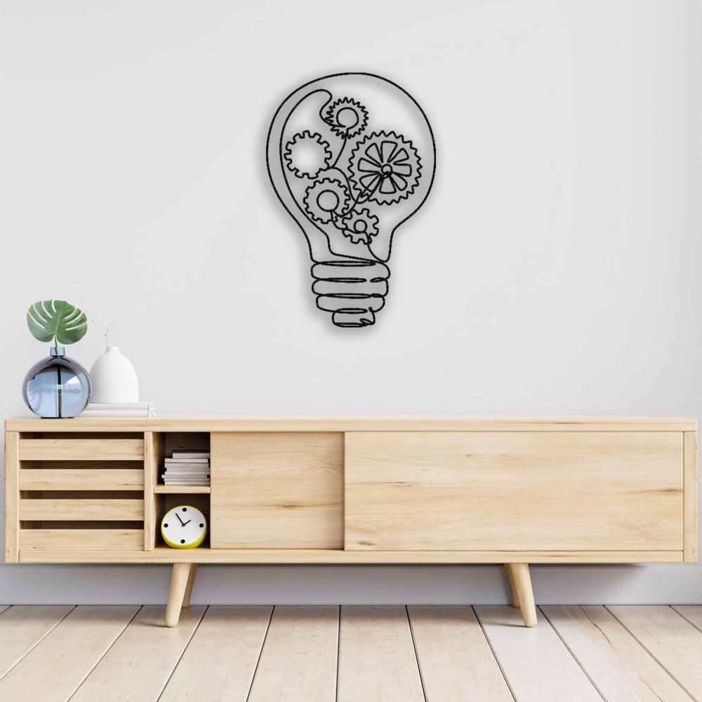 Light bulb-shaped metal wall art featuring detailed gear designs, displayed above a minimalist wooden cabinet with sliding panels and open shelving, styled with decorative items.