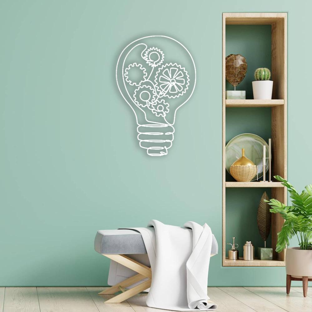 Minimalist room with a mint green wall featuring a white light bulb-shaped metal wall art design with gears, complemented by a wooden shelving unit showcasing decor items and a cozy bench draped with a white throw.