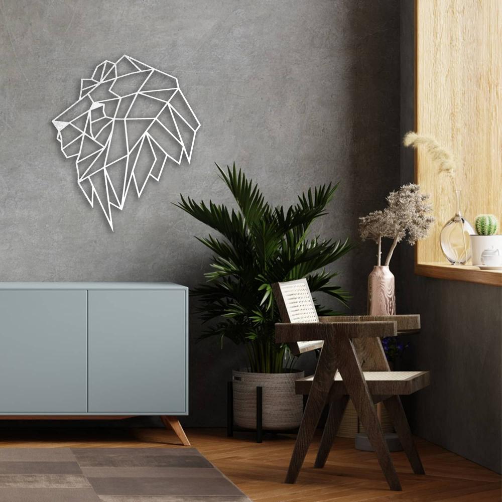 A white geometric lion head metal wall art mounted on a textured grey wall above a stylish cabinet with potted plants and decor.