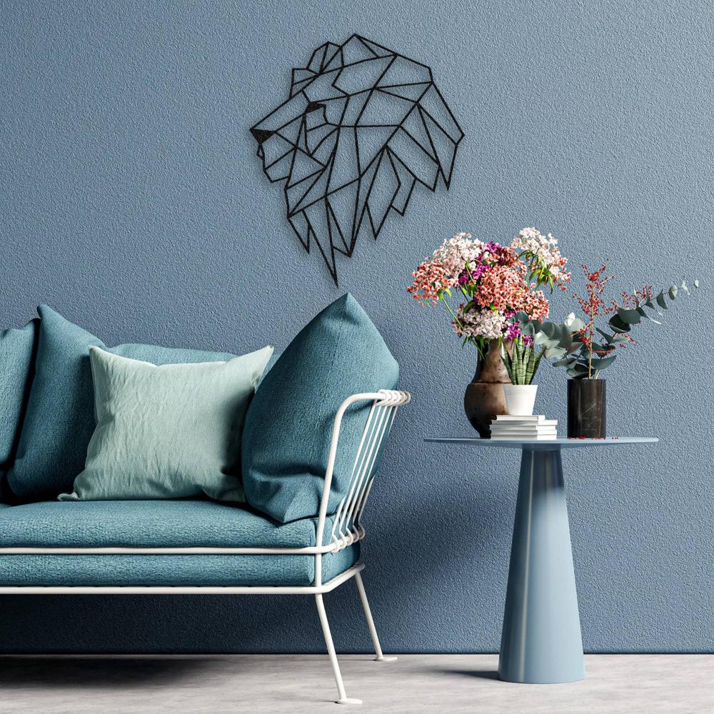 A geometric lion head metal wall art displayed in a modern living room with a blue accent wall and decorative cushions on a sofa.